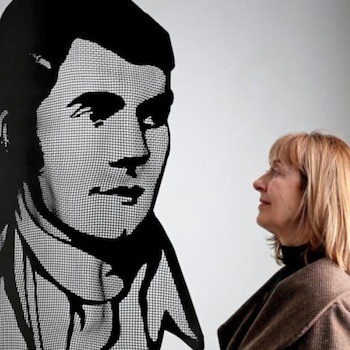 A visitor looks at a Robert Burns portrait made from steel