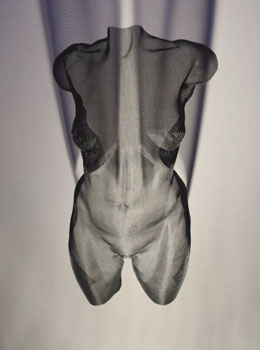 Black woman torso made of wired mesh - suspended with shadow projection