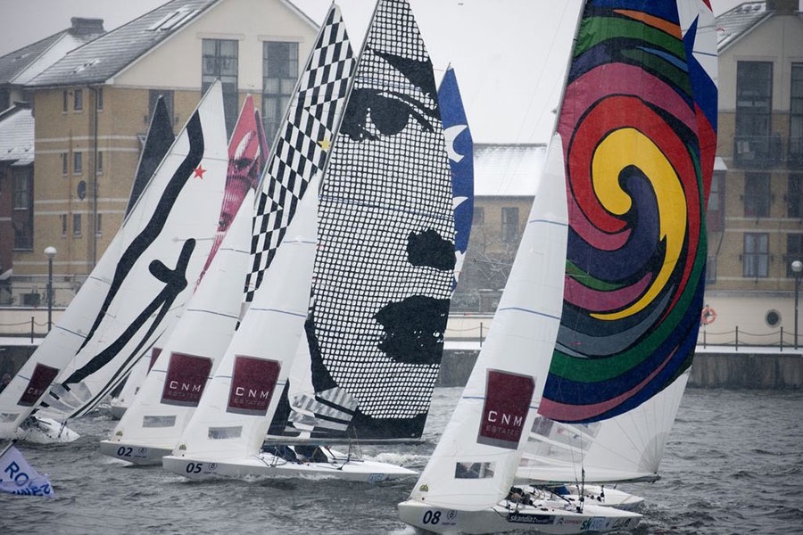 Olympic racing vessels depicting art images on sails