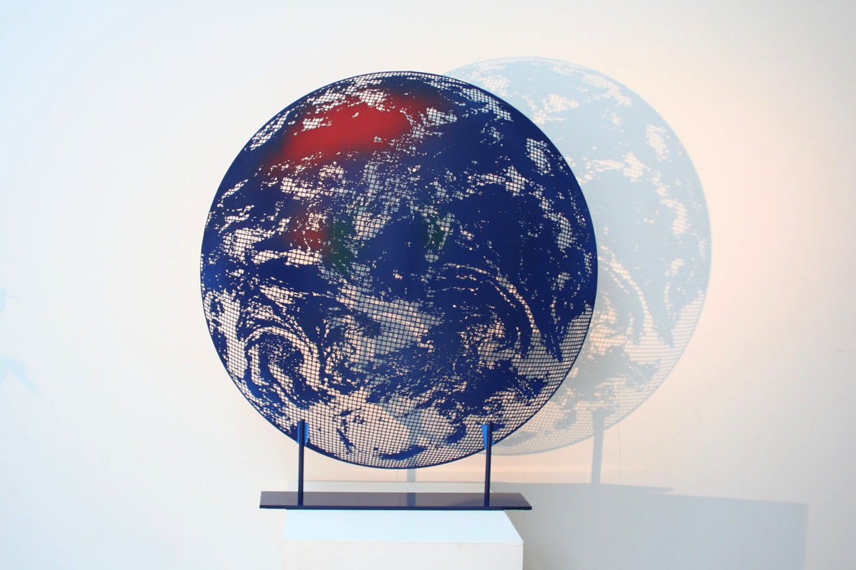 Our planet as a steel sculpture with stunning shadow reflections