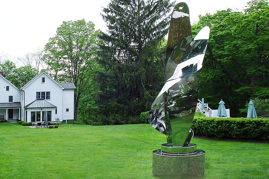 Large garden-sculpture in semi-transparten stainless steel. Abstract leave shapes with surprise portrait