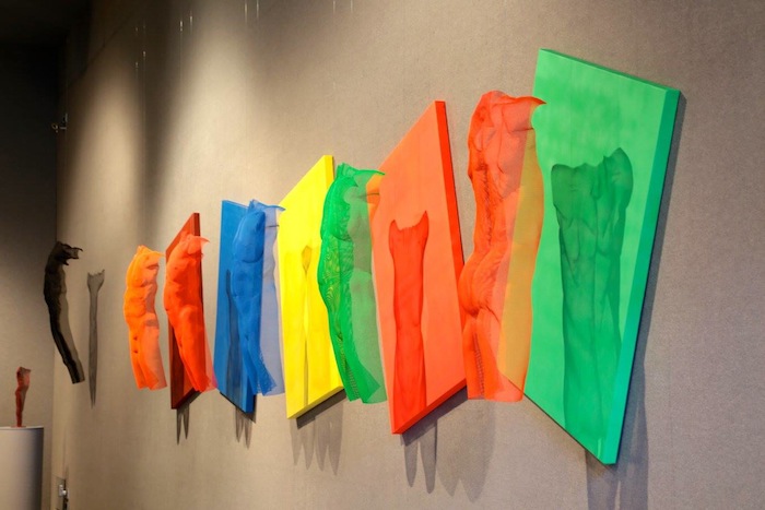 wire-mesh torso sculptures in neon colours by David Begbie