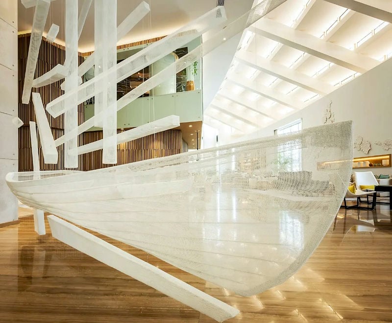 Large sculpture of a floating boat at a Dubai Hotel lobby - made of white-painted bronzemesh