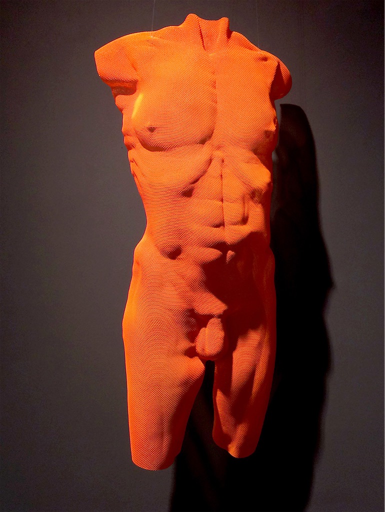 A wire-sculpture of a male torso in bright-red by artist David Begbie