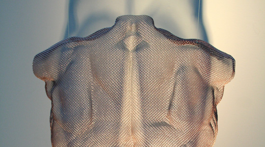 Muscular shoulders of a wire-mesh body portrait made from bronze-mesh